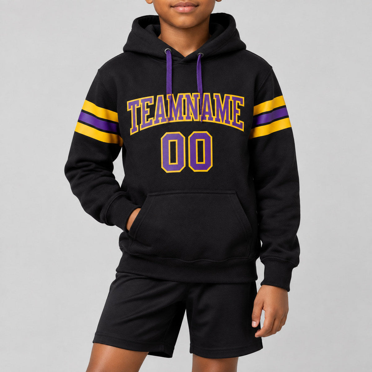 Custom Black Football Pullover Hoodie with Purple and Gold Lettering youth size worn by child model