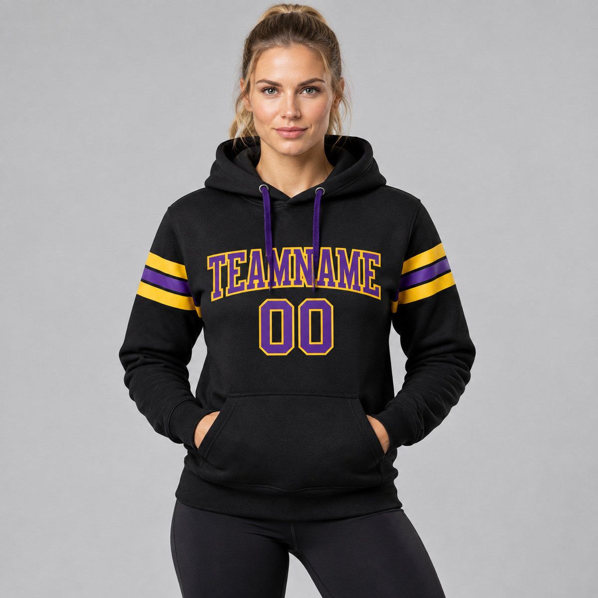 Custom Black Football Pullover Hoodie with Purple and Gold Lettering worn by female model