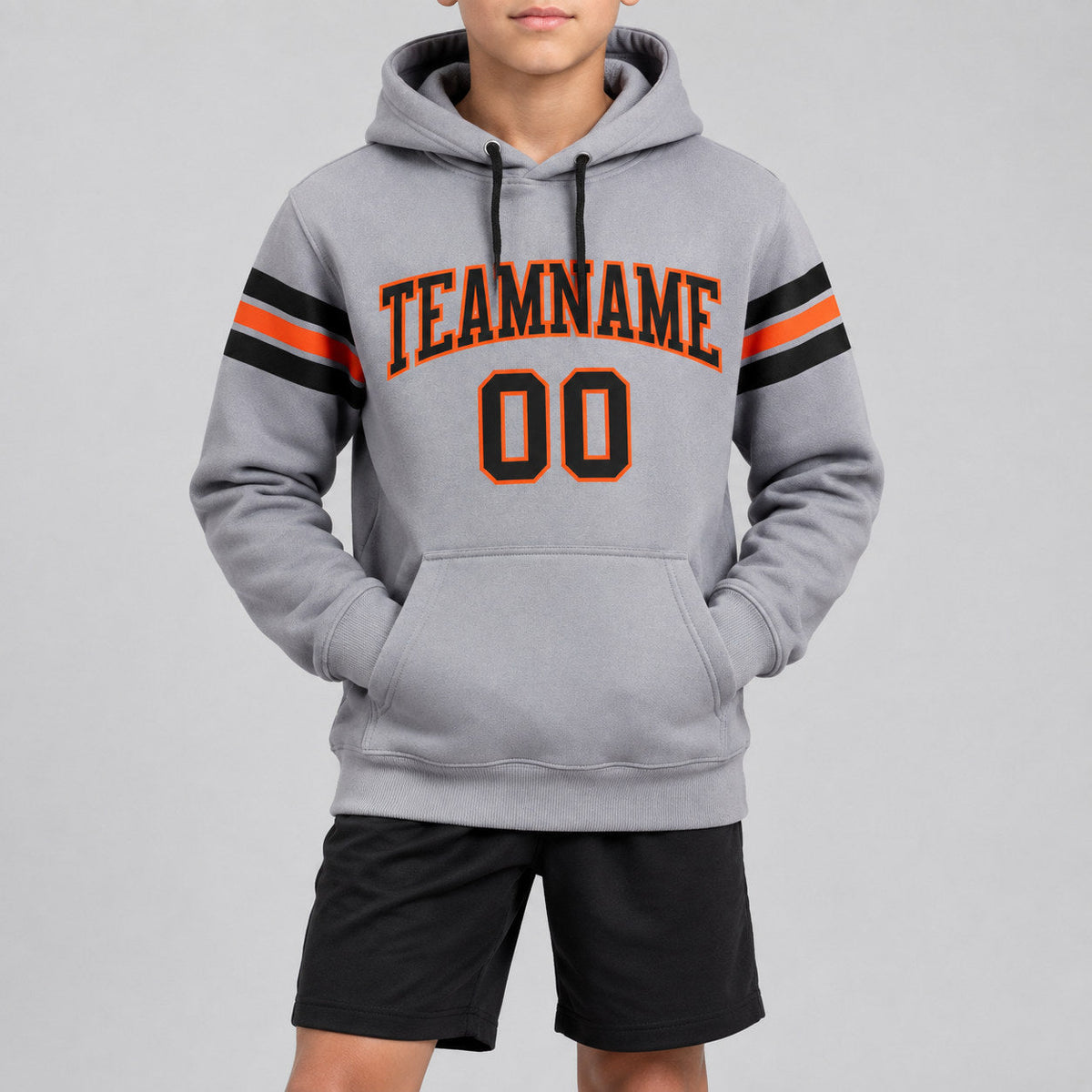 Custom Gray Football Pullover Hoodie with Black and Orange Lettering youth size worn by child model