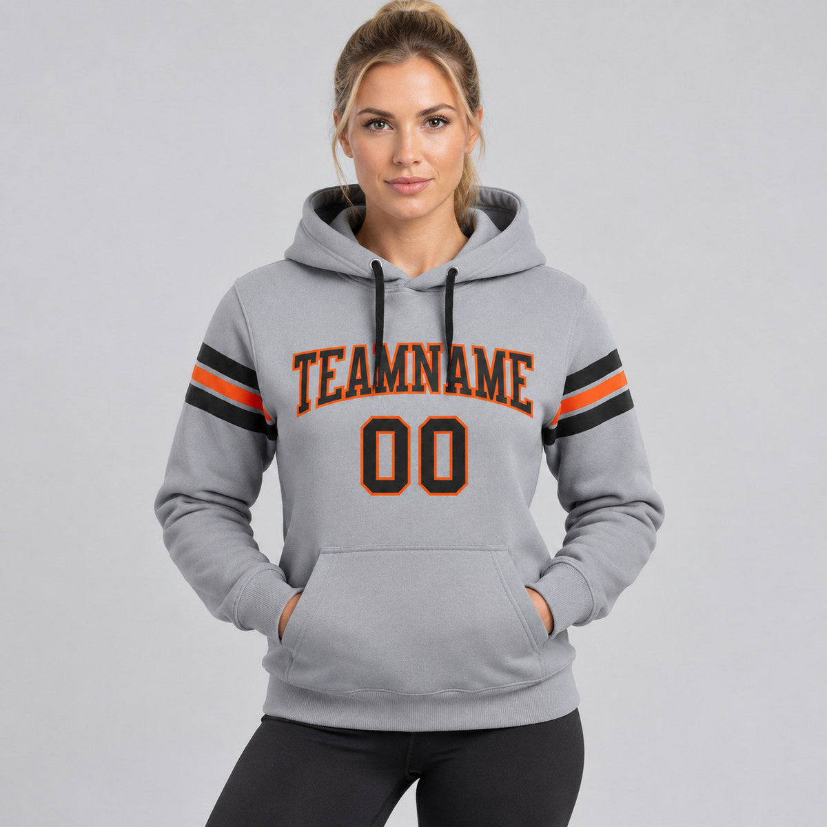 Custom Gray Football Pullover Hoodie with Black and Orange Lettering worn by female model