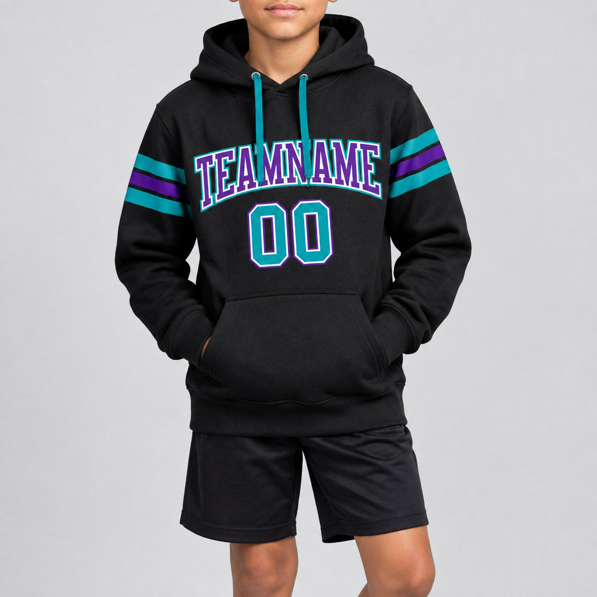 Custom Black Football Pullover Hoodie with Teal and Purple Lettering youth size worn by child model