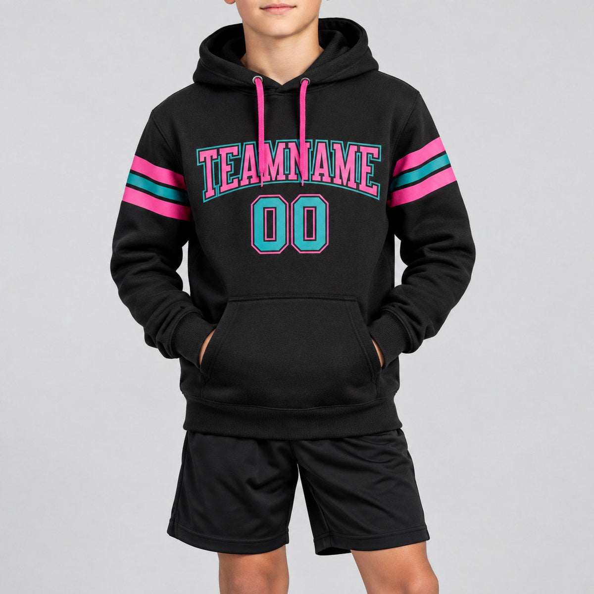 Custom Black Football Pullover Hoodie with Teal and Pink Lettering youth size worn by child model