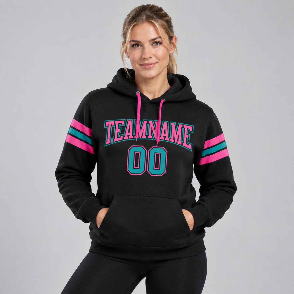 Custom Black Football Pullover Hoodie with Teal and Pink Lettering worn by female model
