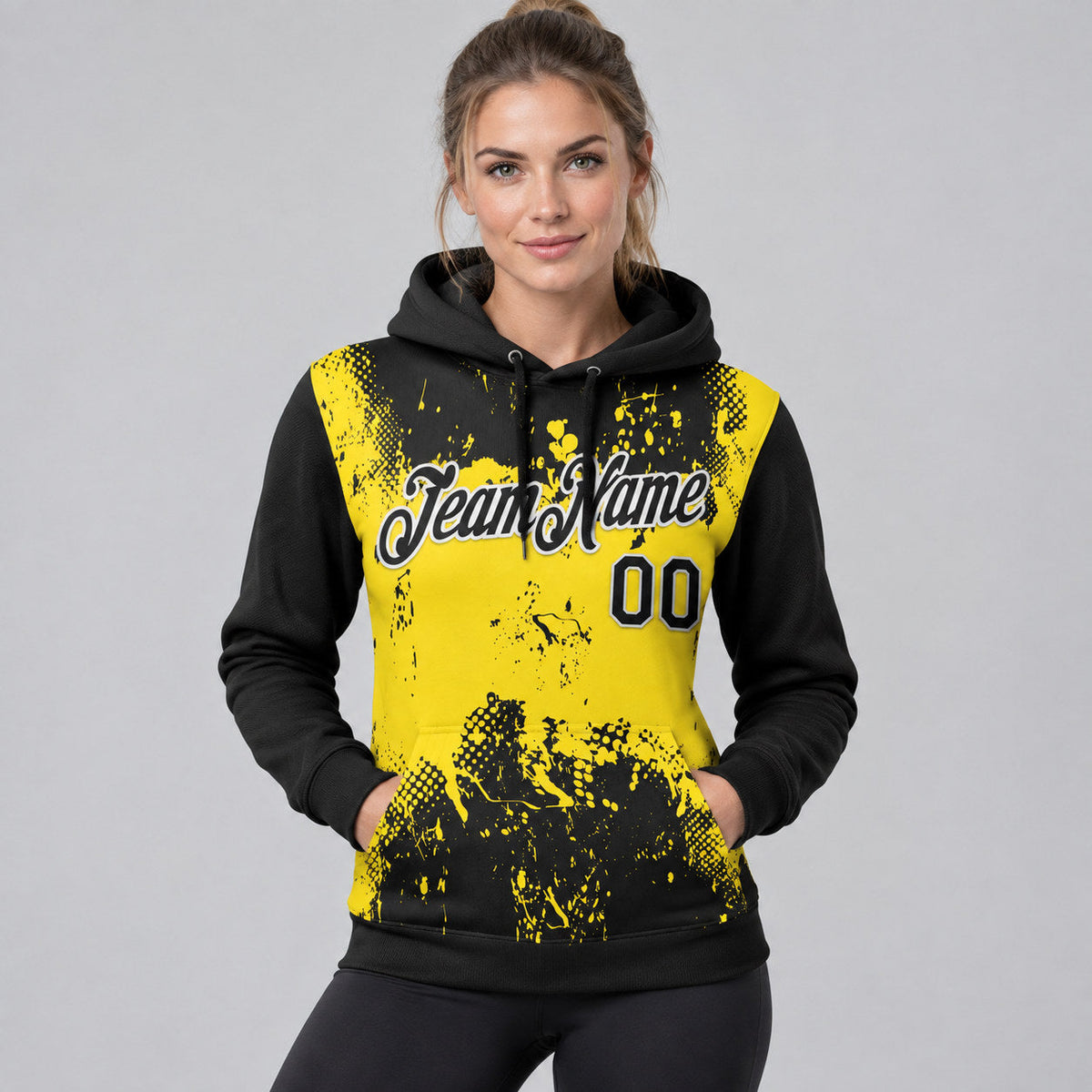 Custom Black Abstract Splatter Grunge Art Pullover Hoodie with Yellow and White Lettering worn by female model