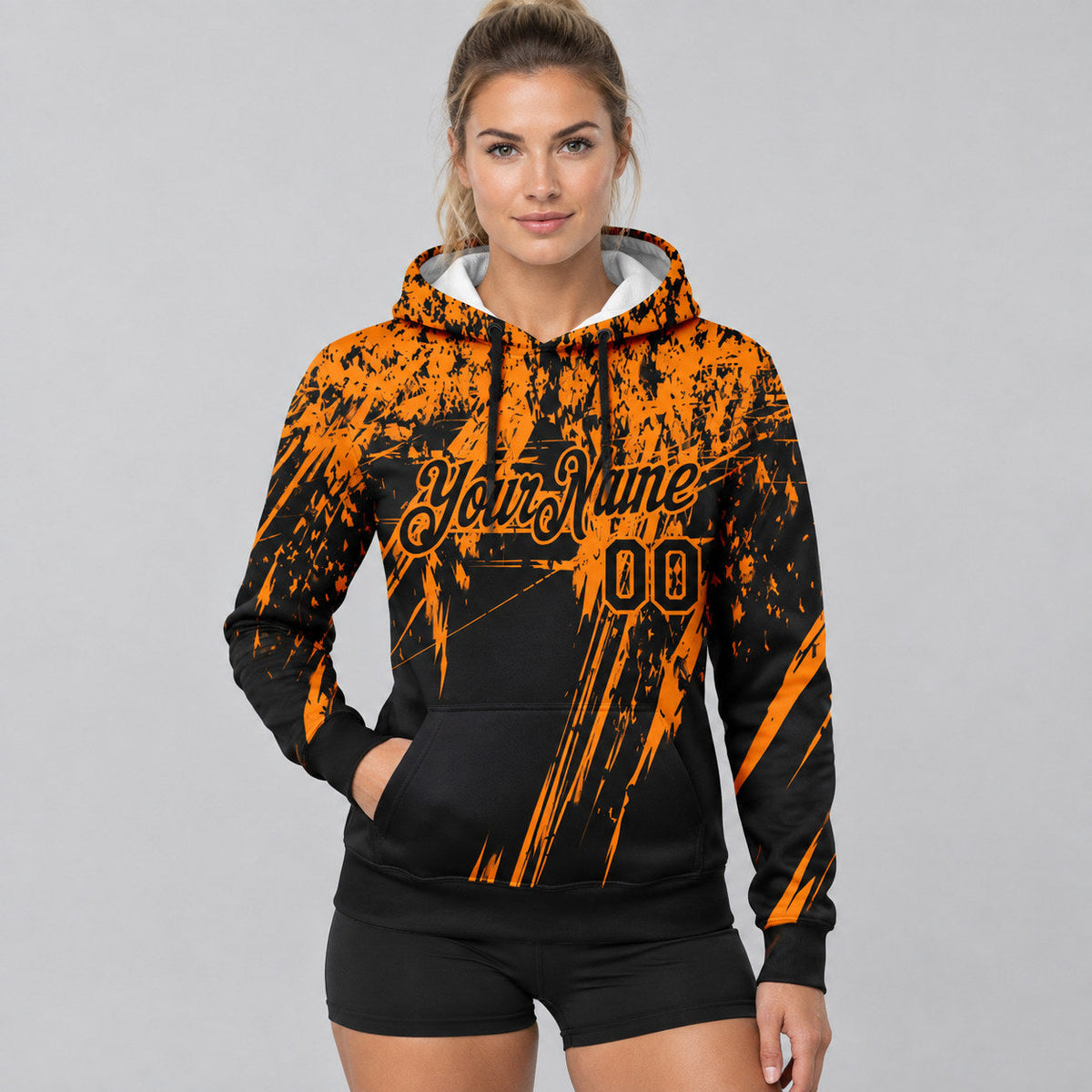 Custom Black Splash Grunge Art Pullover Hoodie with Bay Orange Lettering worn by female model