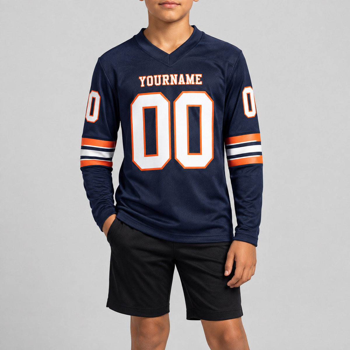 Custom Navy Long Sleeve Authentic Football Jersey with White and Orange Lettering youth size worn by child model