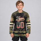Custom Olive Camo Vintage USA Flag Splash Lace Neck Hockey Jersey with Black and Cream Lettering youth size worn by child model