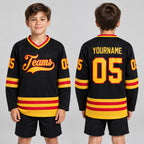 Custom Black Hockey Jersey with Gold and Red Lettering Design 0592 youth size worn by child model