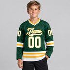 Custom Green Hockey Jersey with White and Gold Lettering youth size worn by child model