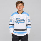 Custom White Lace Neck Hockey Jersey with Light Blue and Steel Gray Lettering Design 1938 youth size worn by child model