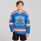 Custom Blue Hockey Jersey with Orange and White Lettering youth size worn by child model