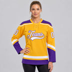 Custom Gold Lace Neck Hockey Jersey with White and Purple Lettering worn by female model
