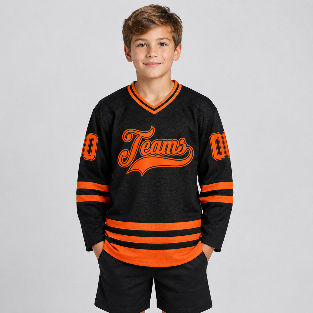 Custom Black Hockey Jersey with Orange Lettering Design 2453 youth size worn by child model