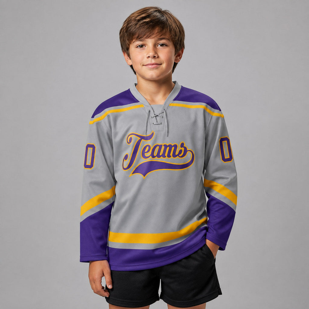 Custom Gray Lace Neck Hockey Jersey with Purple and Gold Lettering youth size worn by child model