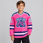 Custom Pink Hockey Jersey with White and Royal Lettering youth size worn by child model