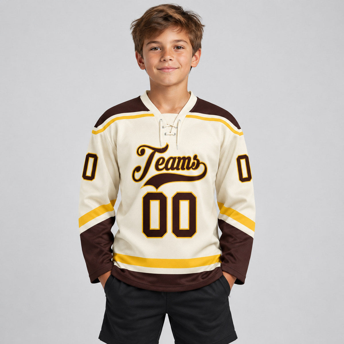 Custom Cream Lace Neck Hockey Jersey with Brown and Gold Lettering youth size worn by child model