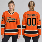 Custom Orange Hockey Jersey with Black and Cream Lettering worn by female model