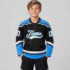 Custom Black Lace Neck Hockey Jersey with White and Powder Blue Lettering youth size worn by child model