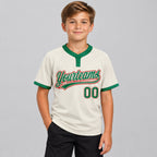 Custom Cream Two Button Softball Jersey with Kelly Green and Red Lettering youth size worn by child model