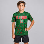 Custom Green Abstract Fragment Art Sublimated Soccer Jersey with Red and Kelly Green Lettering youth size worn by child model