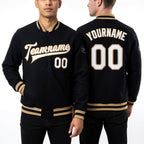 Custom Black White-Old Gold Bomber Full-Snap Varsity Letterman Jacket worn front and back