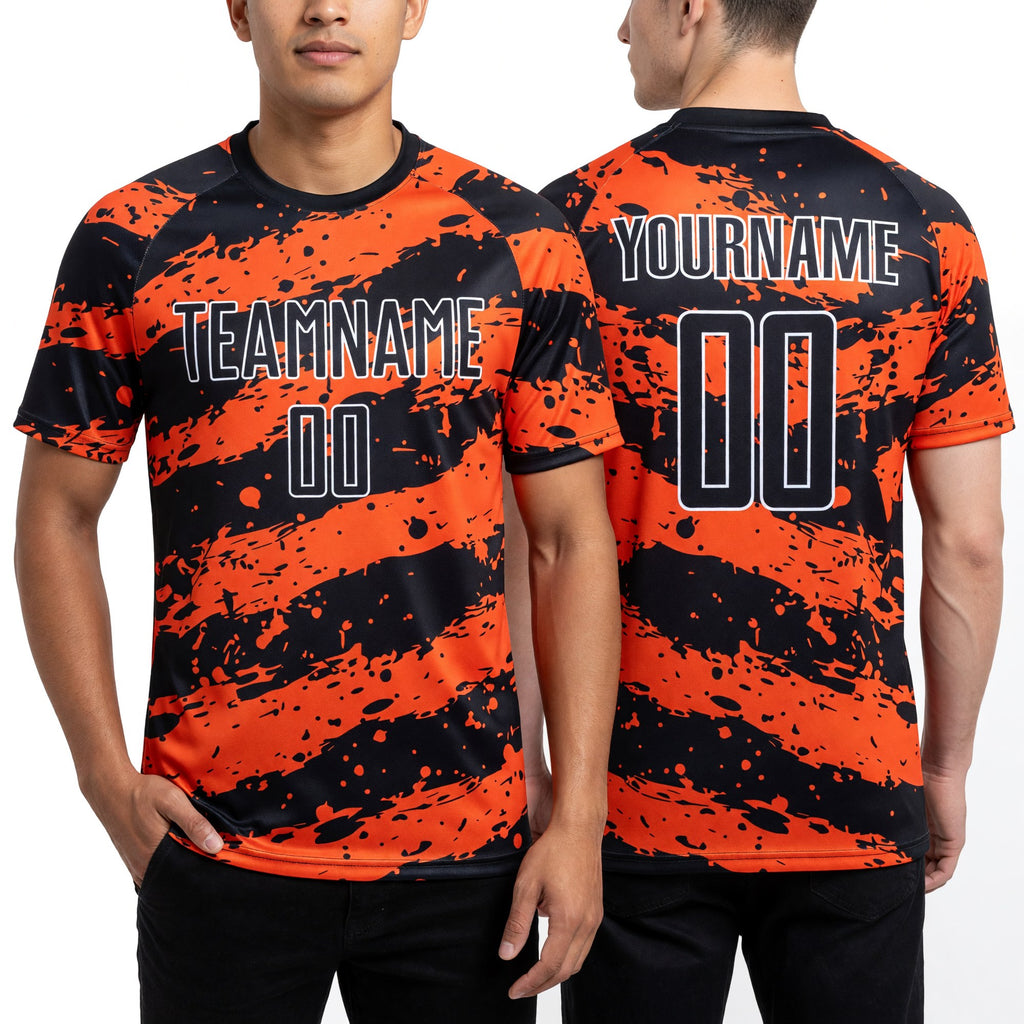 Custom Black Orange-White Splash Sublimation Soccer Uniform Jersey worn front and back