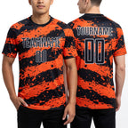 Custom Black Orange-White Splash Sublimation Soccer Uniform Jersey worn front and back